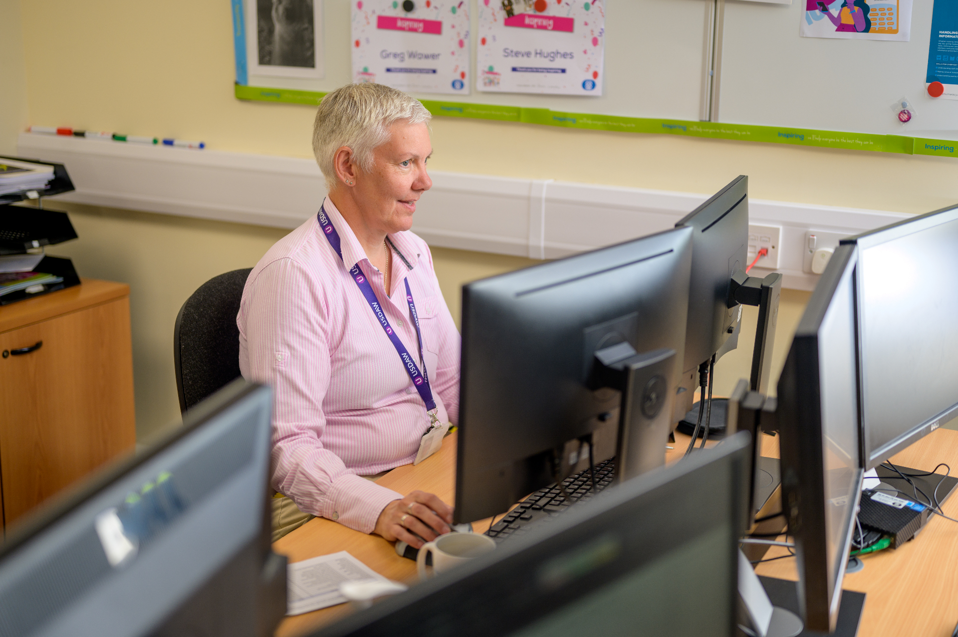 An advisor working at a computer providing information and guidance