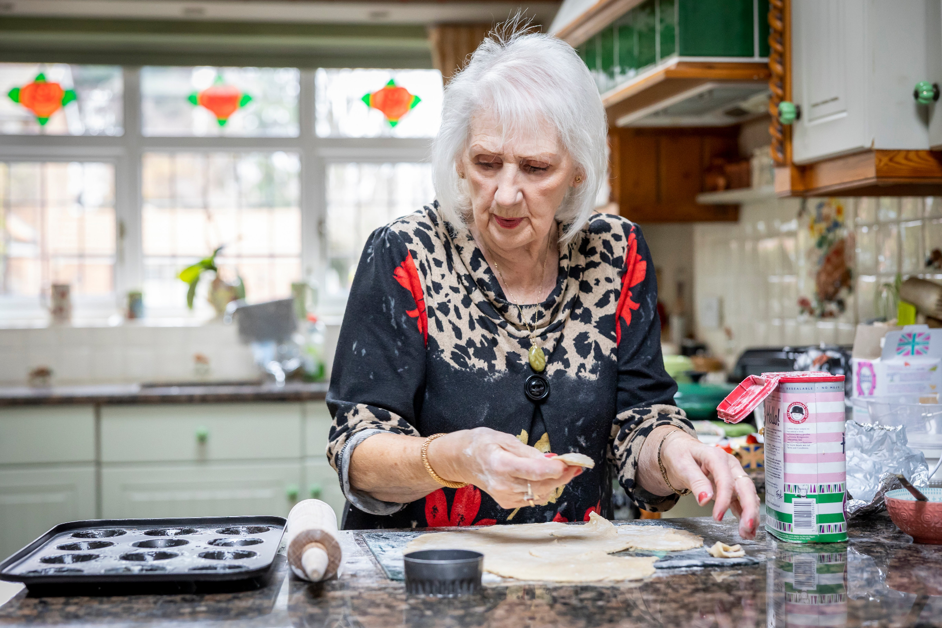 Older woman preparing food in her kitchen at home