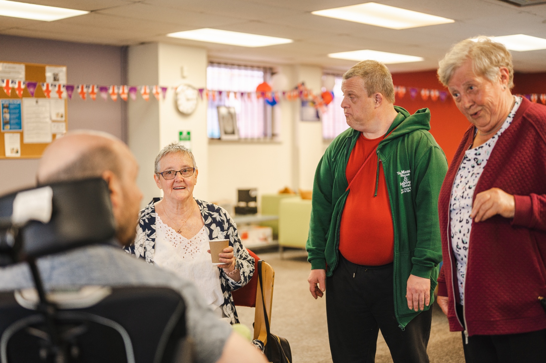 Members chatting together over coffee at a day centre social session