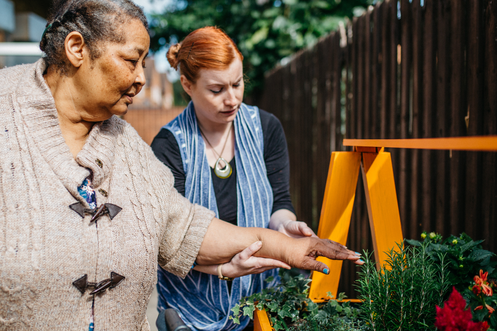 Older woman gardening with a support worker