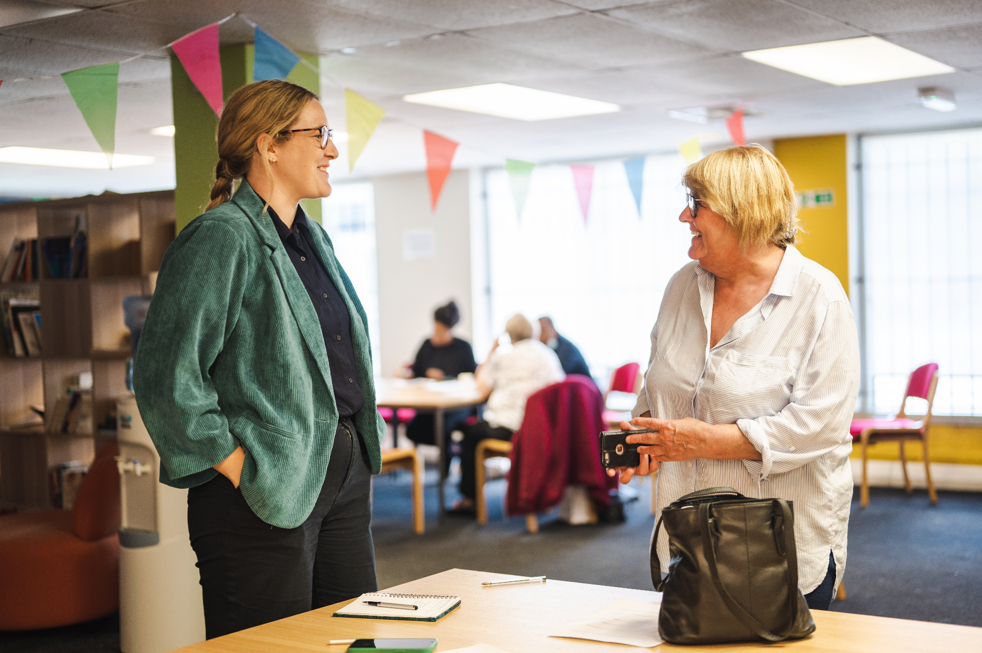 Carers Hub adviser chatting with a carer in a community centre