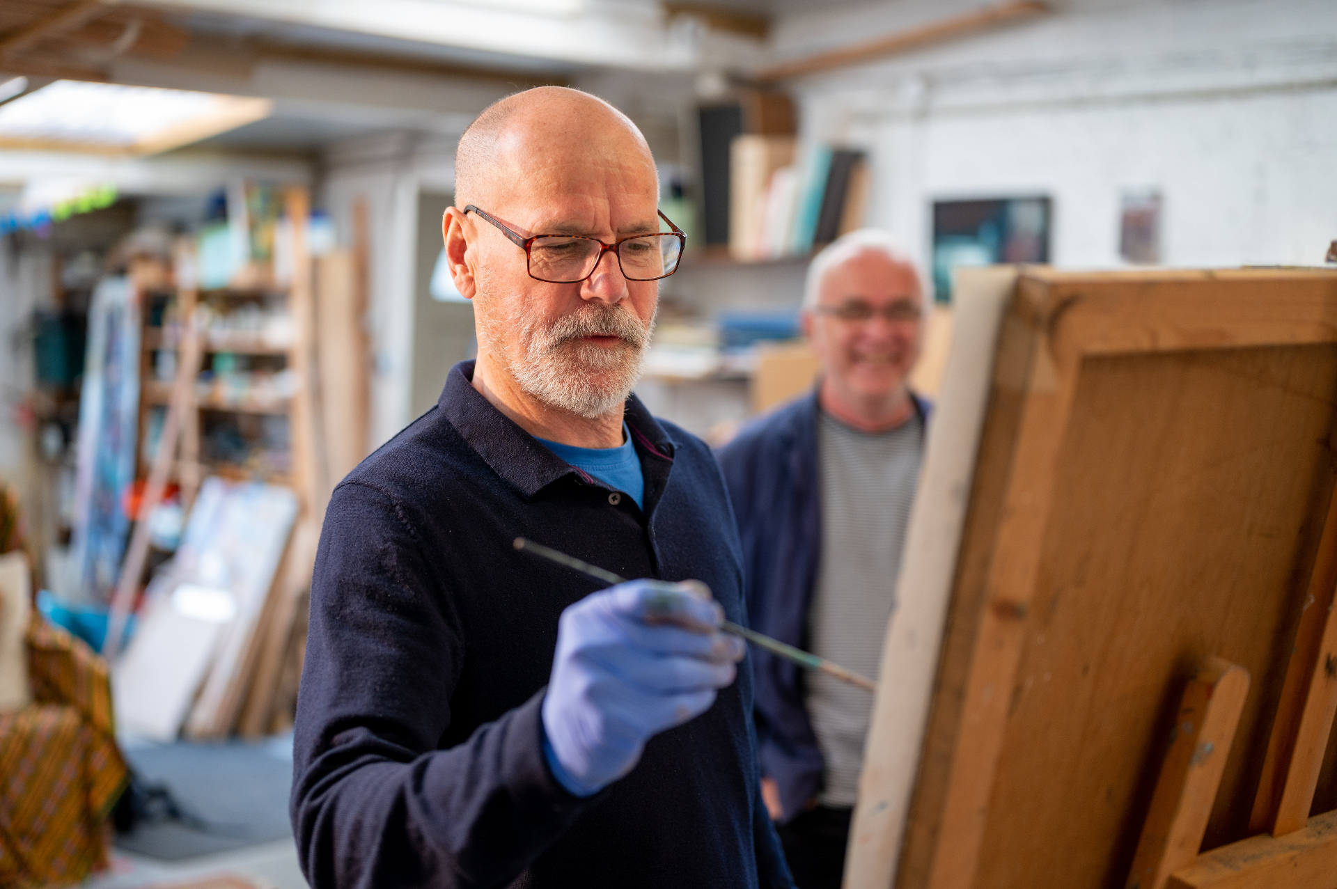 A man painting during a community art session