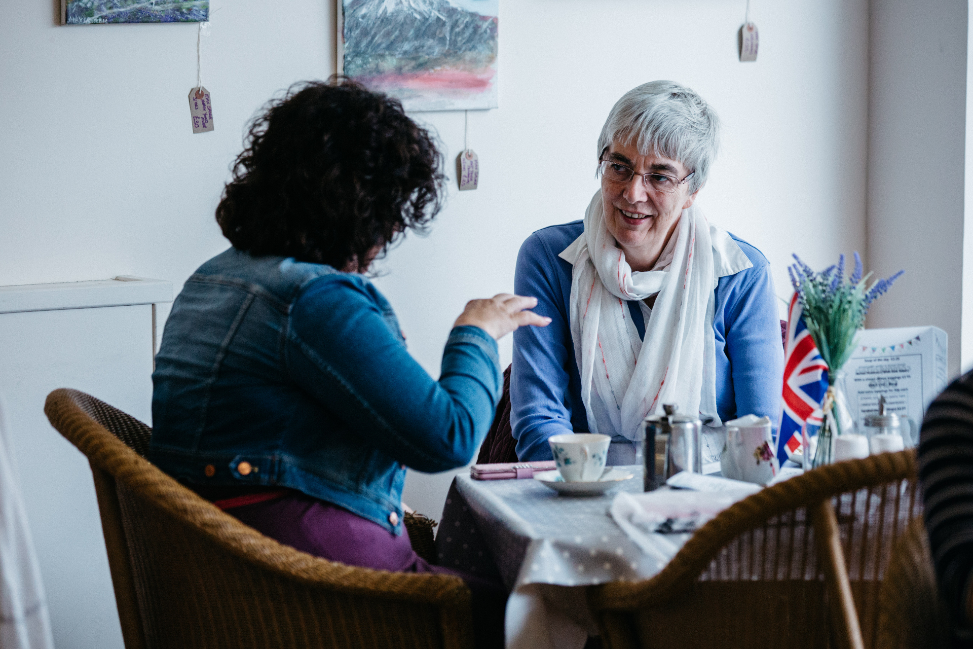 Two women talking together over coffee